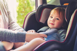 Toddler,Girl,Buckled,Into,Her,Car,Seat